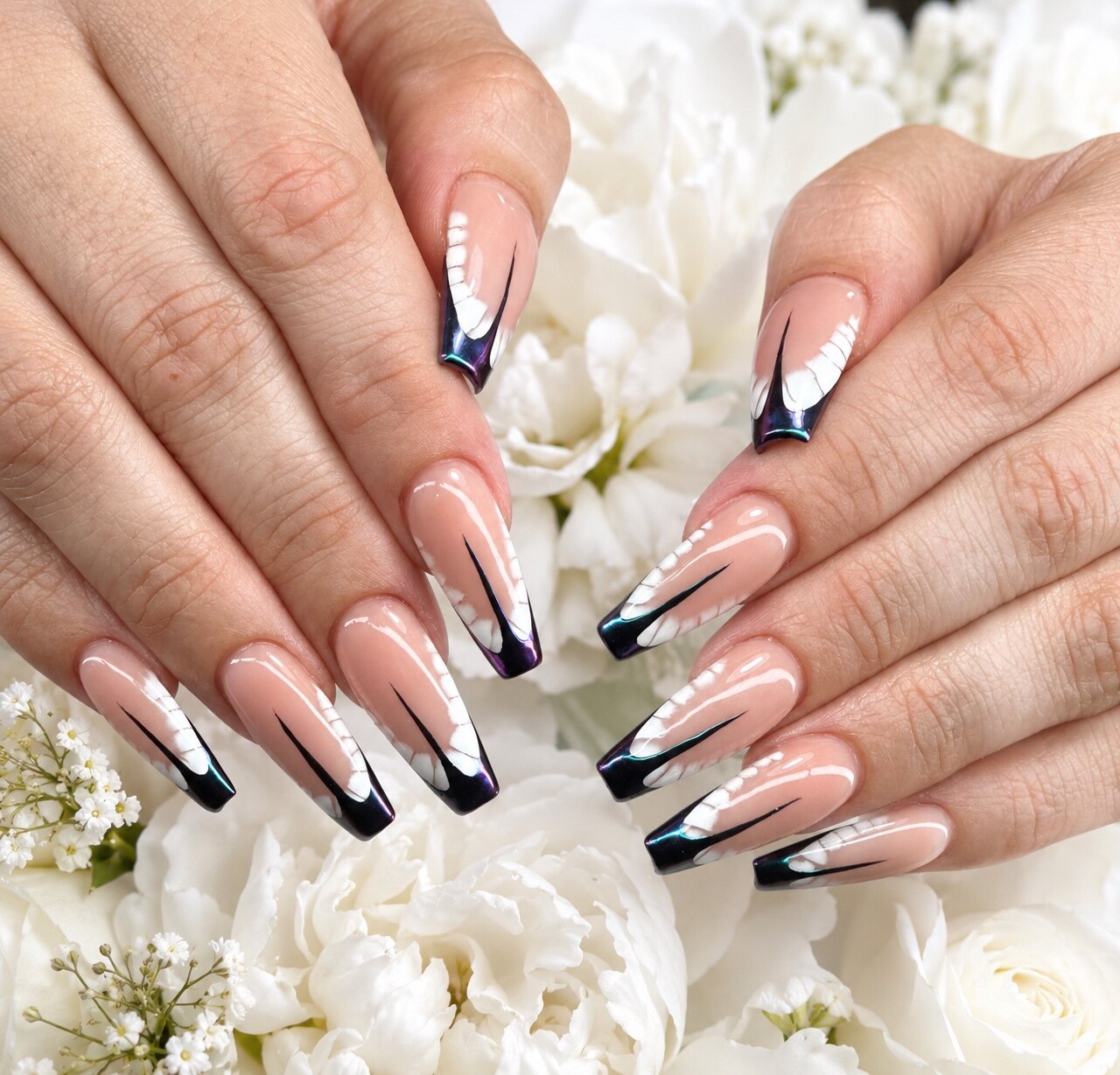 Long butterfly-wing nail design by Vivid Nails & Spa